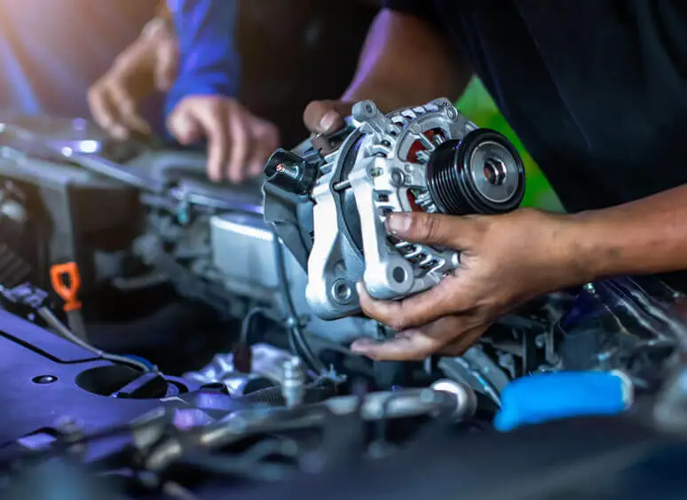 Mechanic installing car alternator