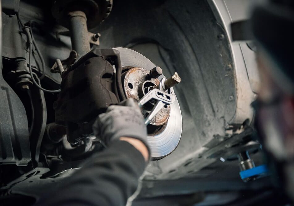 Mechanic working on car brake system